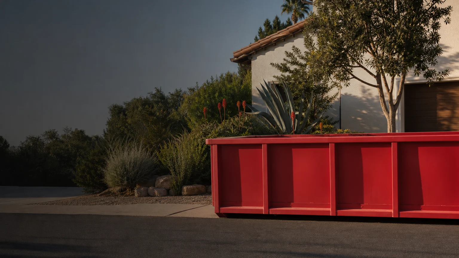 Red roll-off dumpster on a Chula Vista residential driveway
